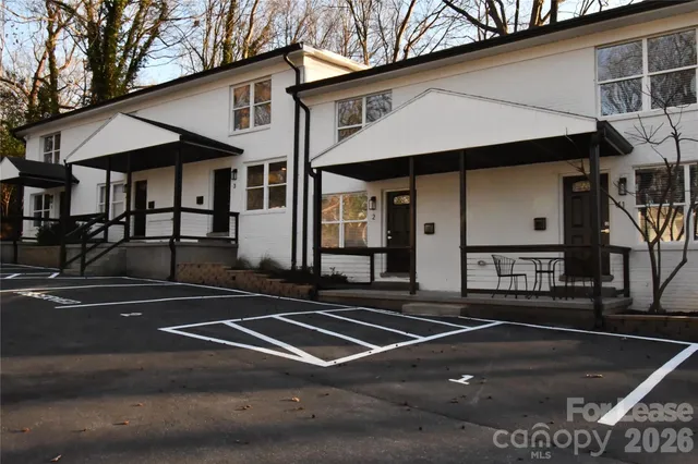 a view of a white building with a outdoor space
