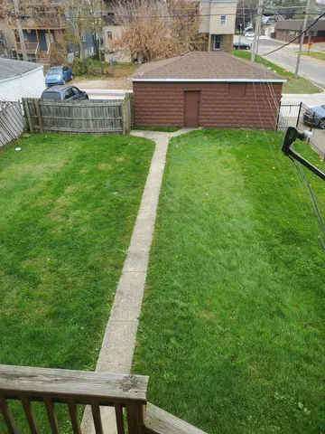 a view of a backyard with a sitting area and a garden