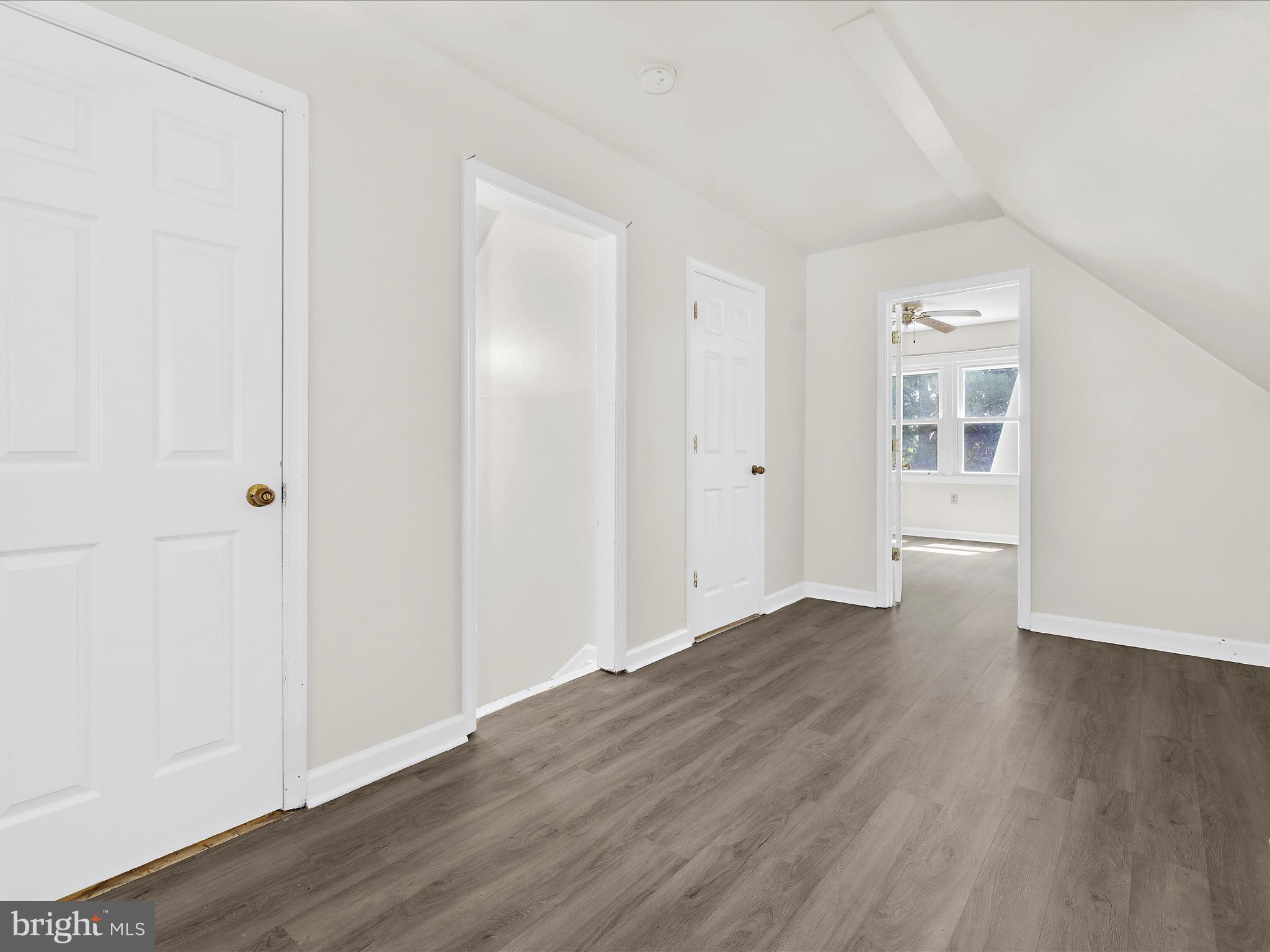 812 Roe Road Barclay, MD 21607 - Photo 13 of 46 an empty room with wooden floor & windows and bathroom