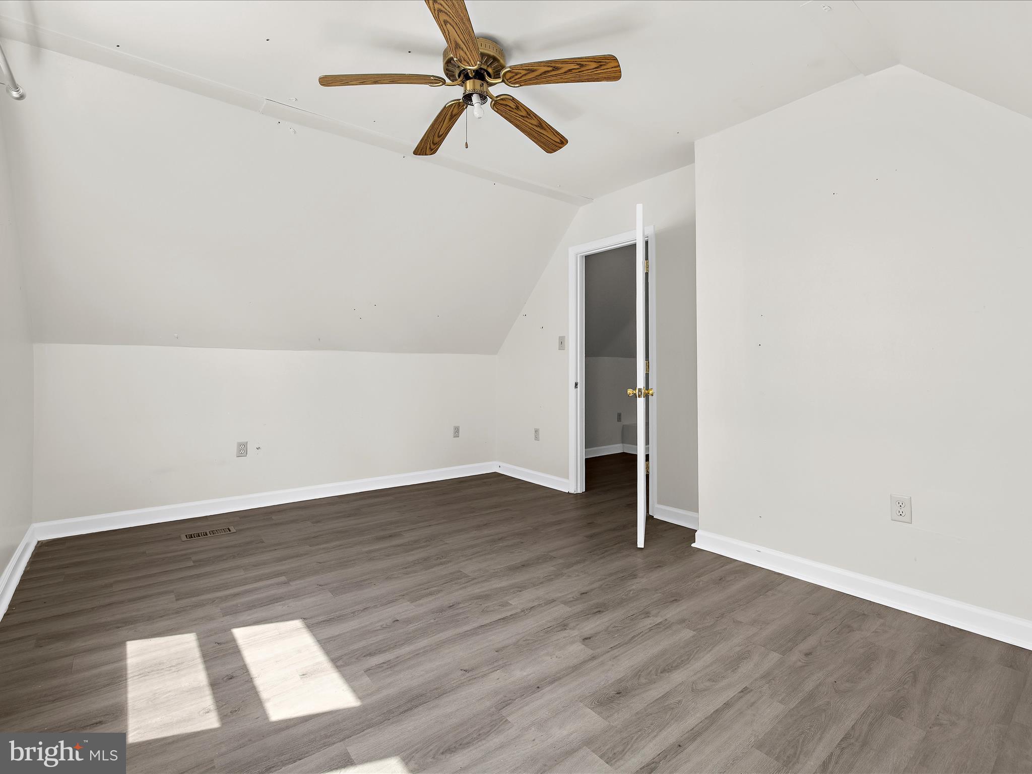 812 Roe Road Barclay, MD 21607 - Photo 19 of 46 an empty room with wooden floor closet and windows