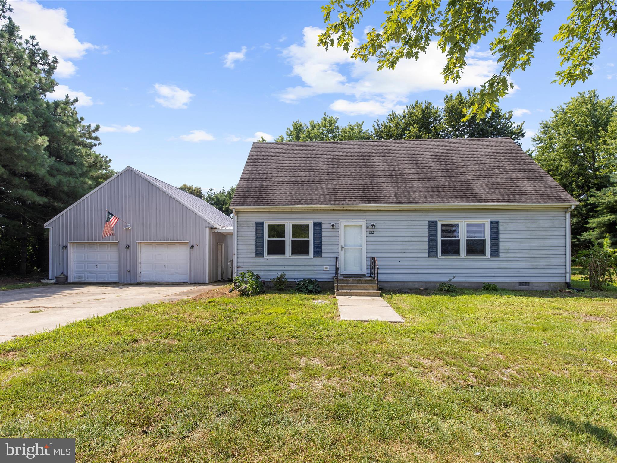 812 Roe Road Barclay, MD 21607 - Photo 2 of 46 a front view of house with yard and trees in the background