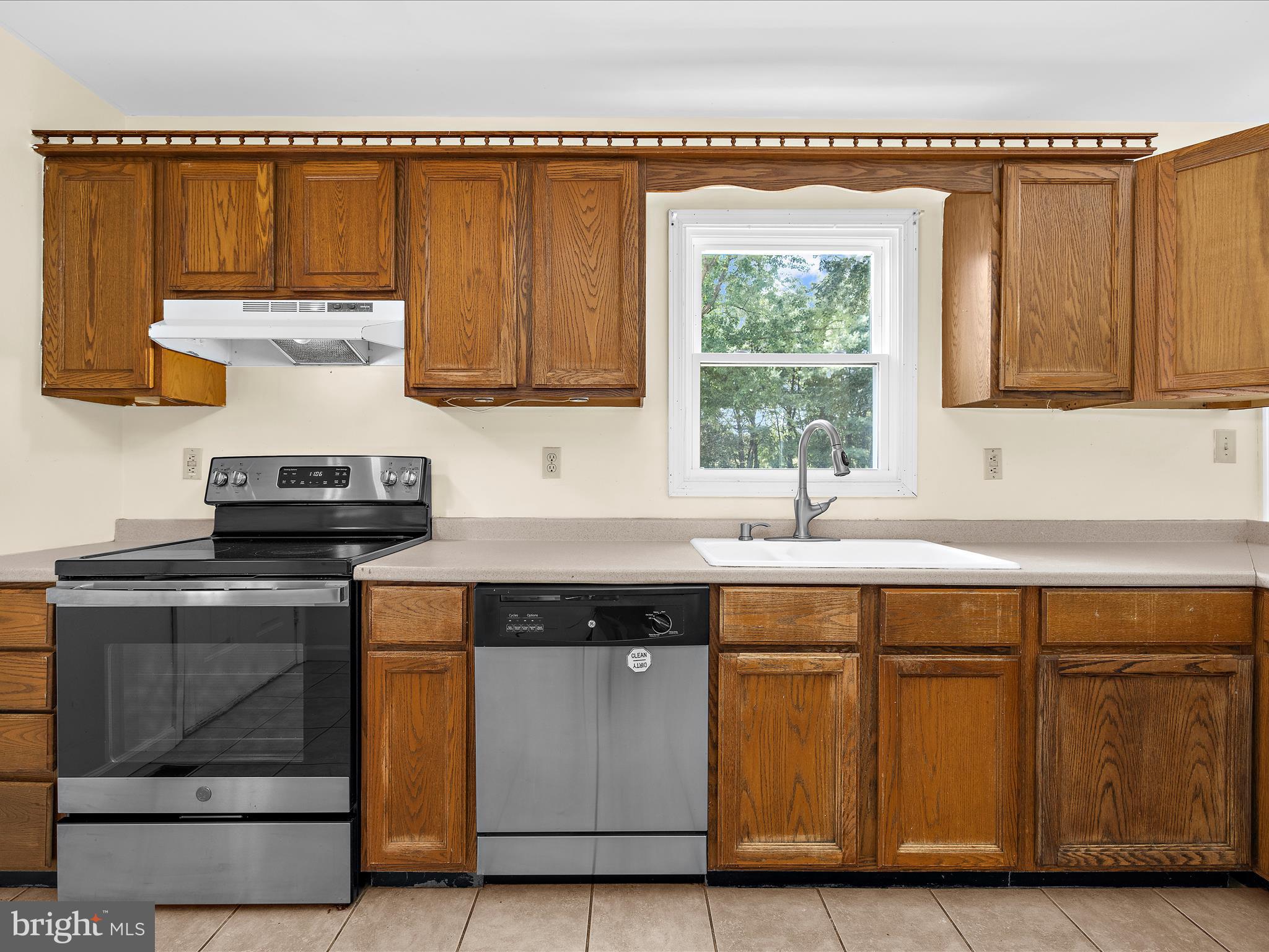 812 Roe Road Barclay, MD 21607 - Photo 26 of 46 a kitchen with a stove and a white cabinet