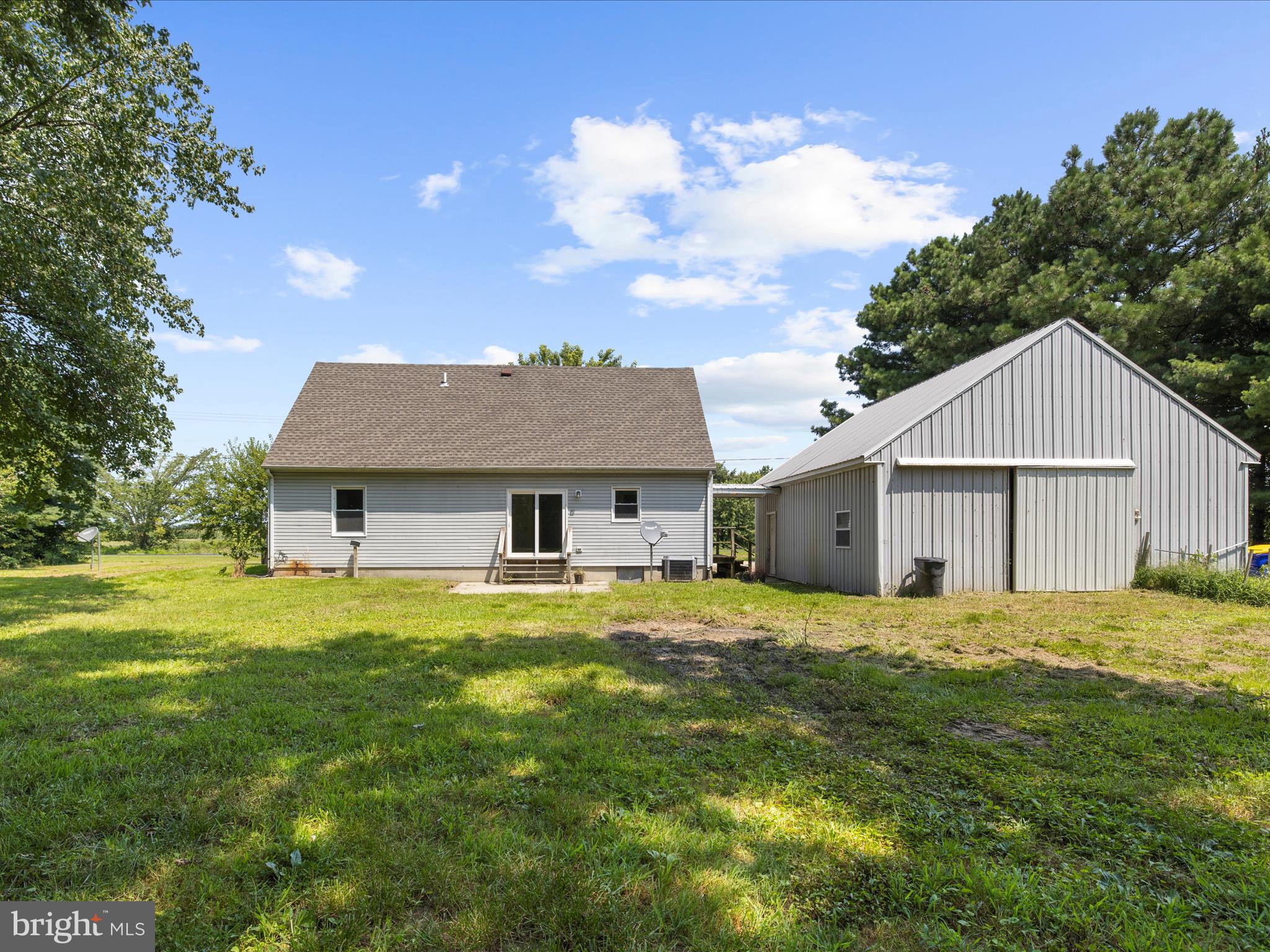 812 Roe Road Barclay, MD 21607 - Photo 33 of 46 a house that is sitting in the grass with large trees