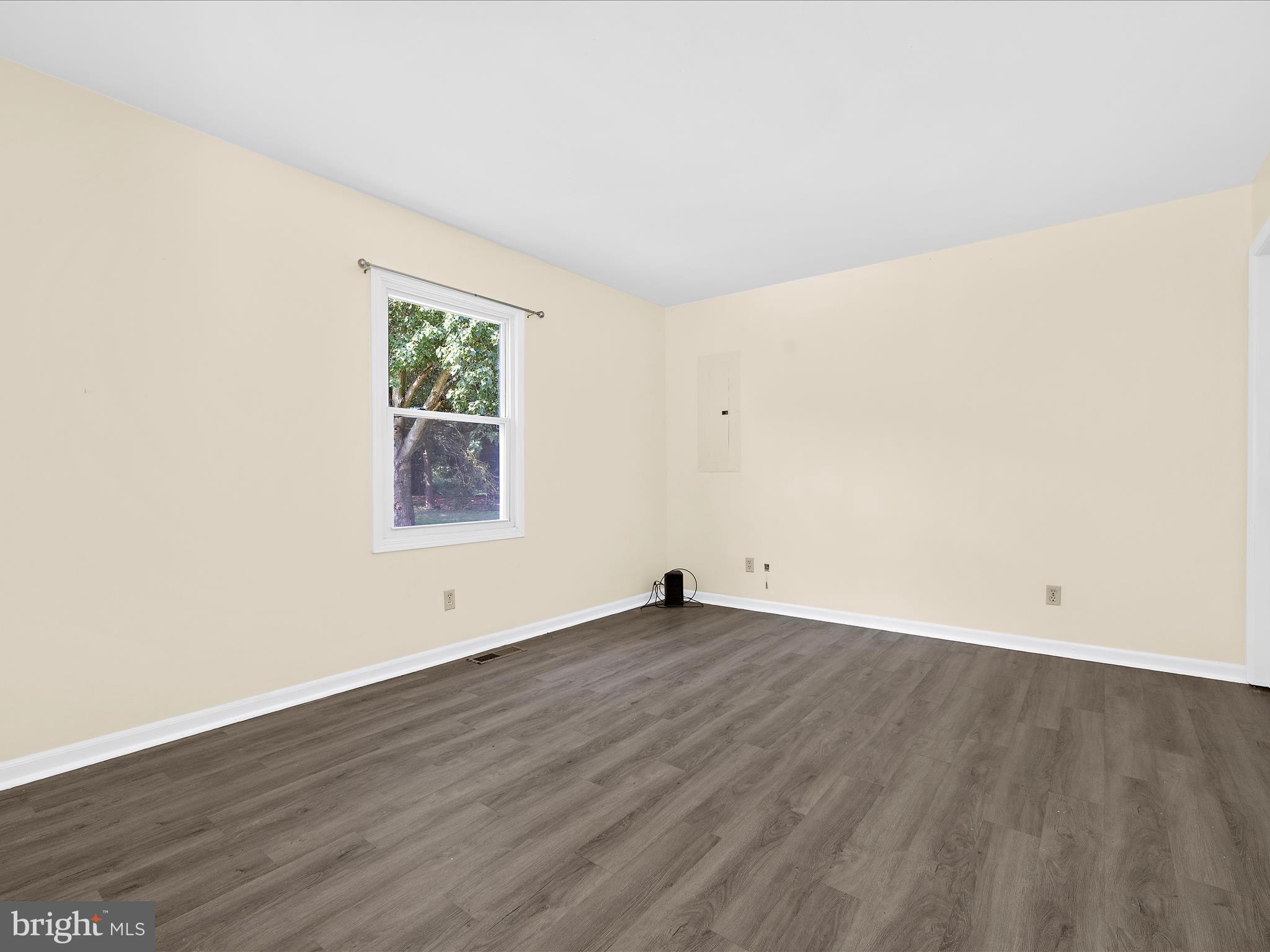 812 Roe Road Barclay, MD 21607 - Photo 6 of 46 an empty room with wooden floor and window
