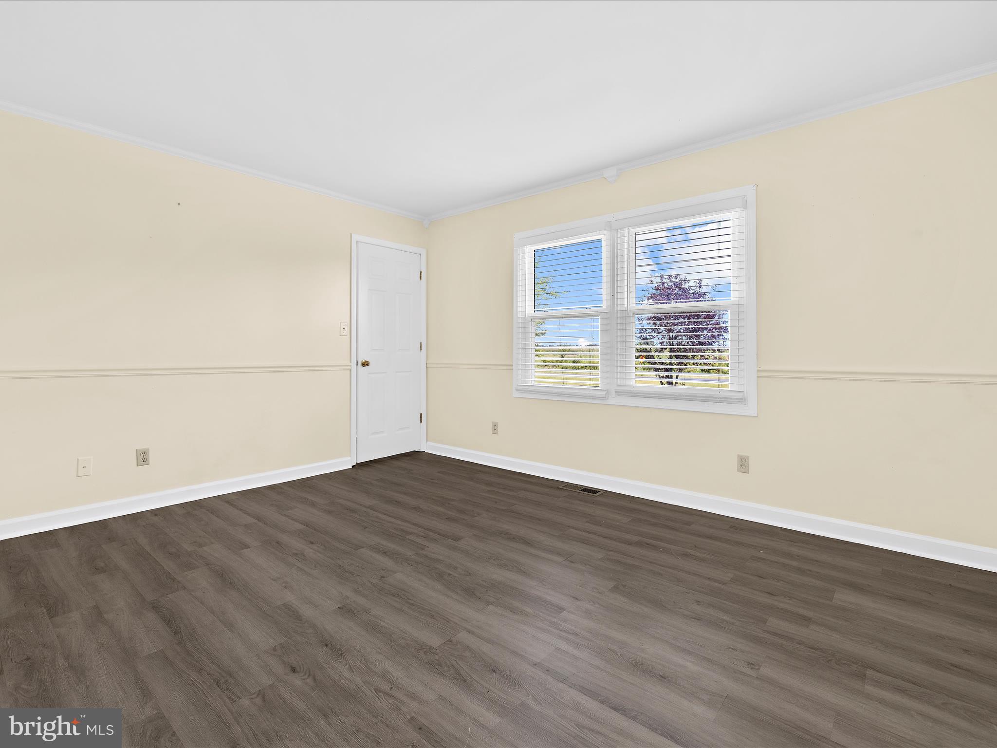 812 Roe Road Barclay, MD 21607 - Photo 9 of 46 an empty room with wooden floor and windows