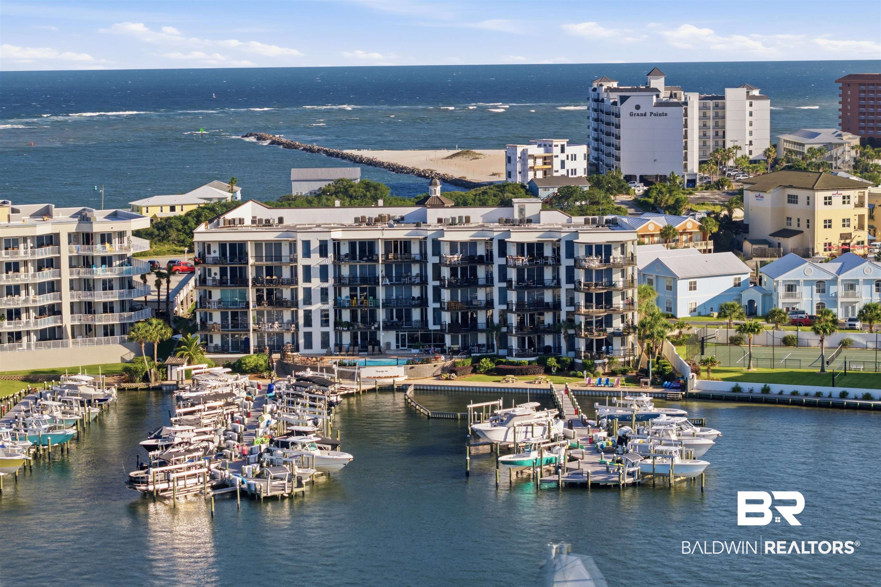 3564 Bayou Road, Unit 203 Orange Beach, AL 36561 - Photo 51 of 53 Marina with multiple boat slips, condominium complex with private balconies, and ocean access