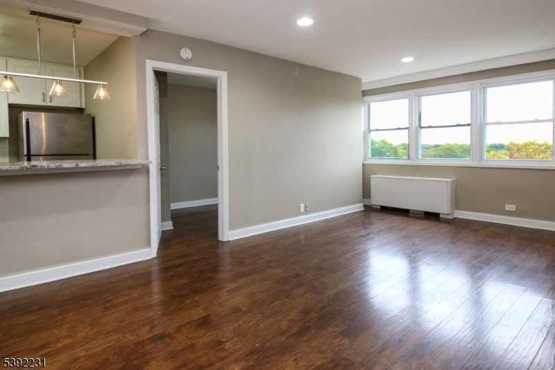 39 East 39th Street Paterson, NJ 07514 - Photo 11 of 15 an empty room with wooden floor and windows