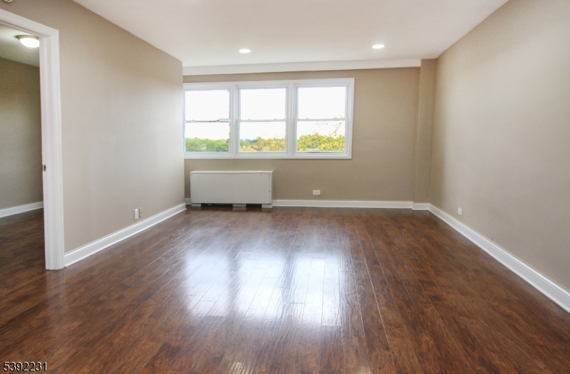 39 East 39th Street Paterson, NJ 07514 - Photo 13 of 15 an empty room with wooden floor and windows