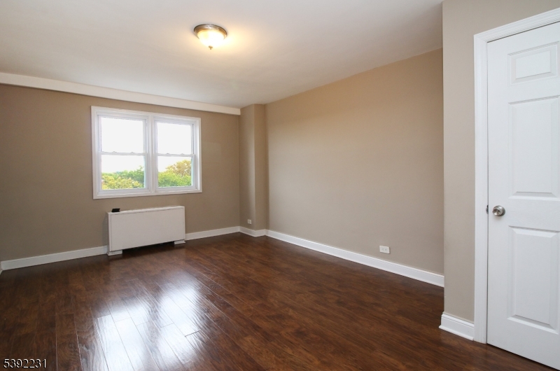 39 East 39th Street Paterson, NJ 07514 - Photo 14 of 15 an empty room with wooden floor and windows