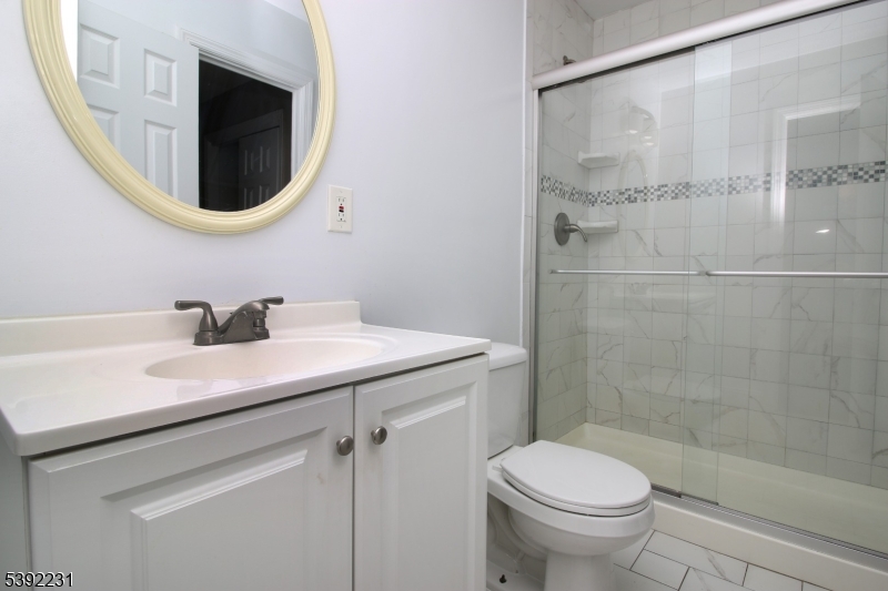 39 East 39th Street Paterson, NJ 07514 - Photo 15 of 15 a bathroom with a sink toilet and a mirror