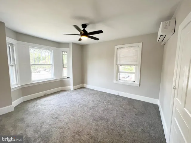 a view of room with a ceiling fan and window