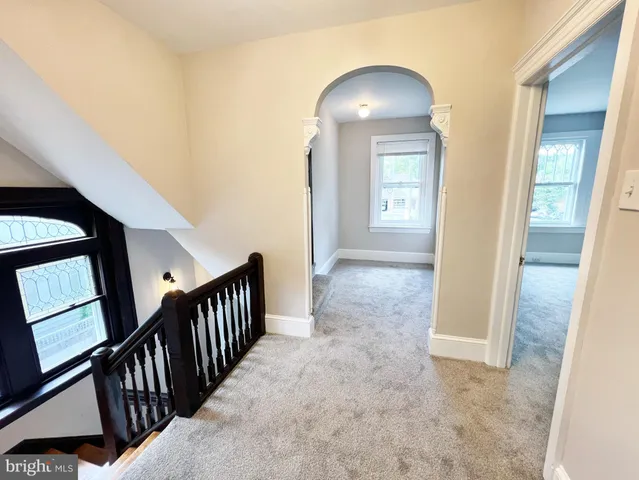 an empty room with windows and cabinet