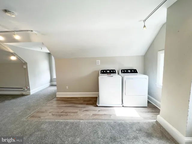 en empty room with windows and entrance