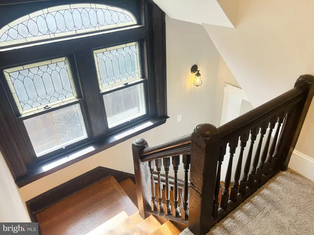 a view of staircase with windows