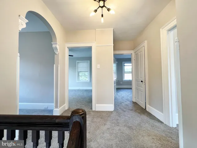 a view of a hallway with wooden shelves