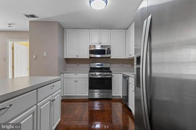a kitchen with a stove and a refrigerator