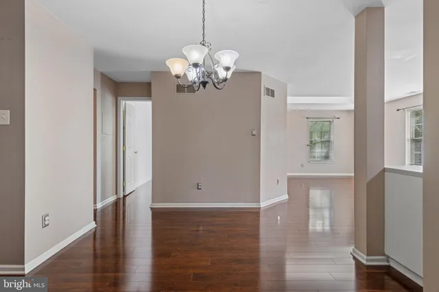 a view of a room with wooden floor