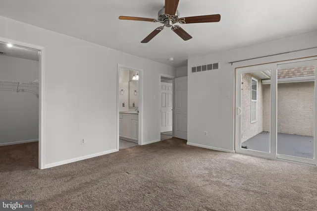 a view of empty room with ceiling fan