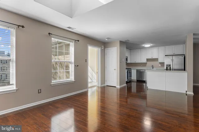 a view of kitchen with wooden floor and windows