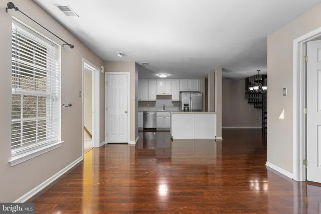 a view of kitchen dining table chairs and refrigerator