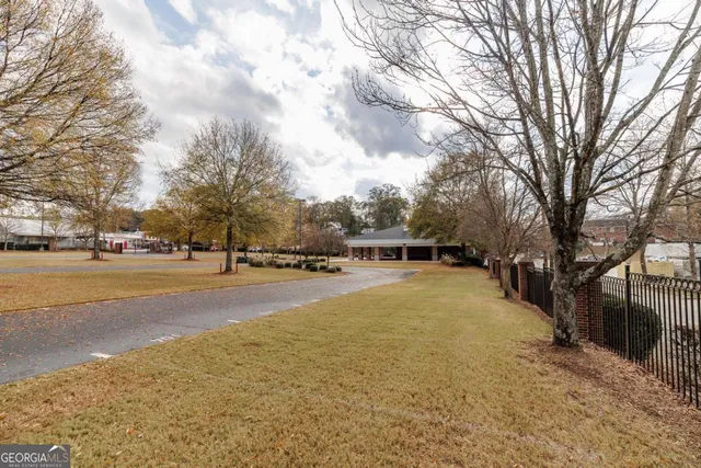 a view of a house with a yard covered with snow