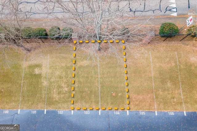 a view of swimming pool with trees in front of house