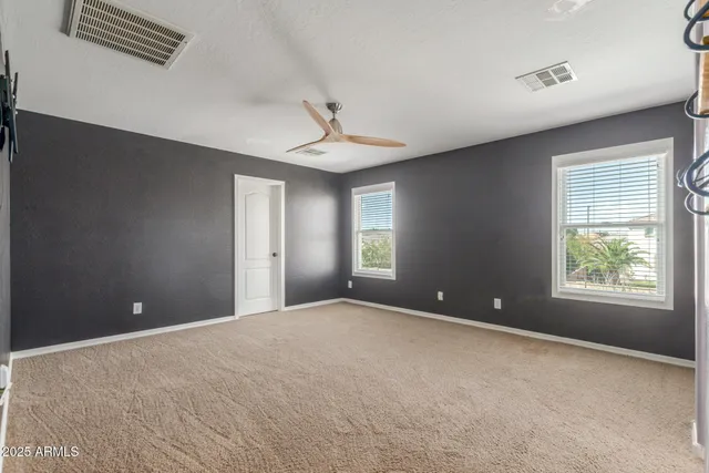 a bedroom with a bed and a painting on the wall
