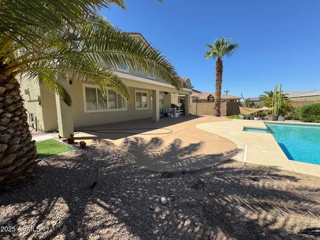 a view of a backyard with wooden fence