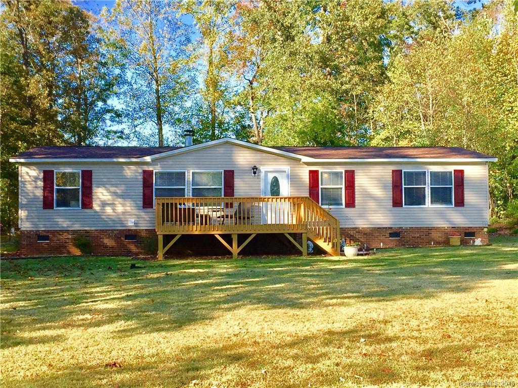 119 Forney Road, Unit 1 Olin, NC 28660 - Photo 1 of 17 a view of a house with a big yard potted plants and large tree