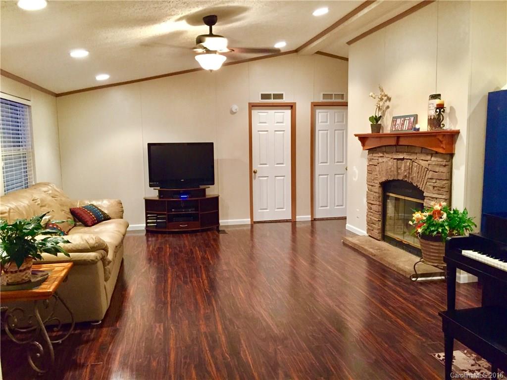 119 Forney Road, Unit 1 Olin, NC 28660 - Photo 2 of 17 a living room with furniture fireplace and flat screen tv