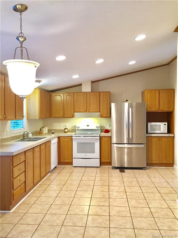 119 Forney Road, Unit 1 Olin, NC 28660 - Photo 5 of 17 a kitchen with stainless steel appliances granite countertop a refrigerator and a sink