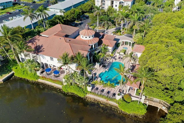 an aerial view of a houses with yard swimming pool and outdoor seating