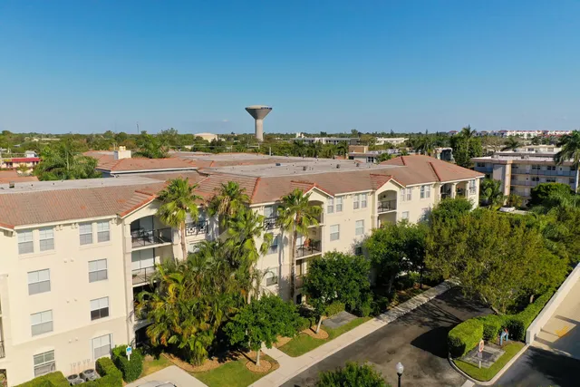 an aerial view of multiple houses with yard
