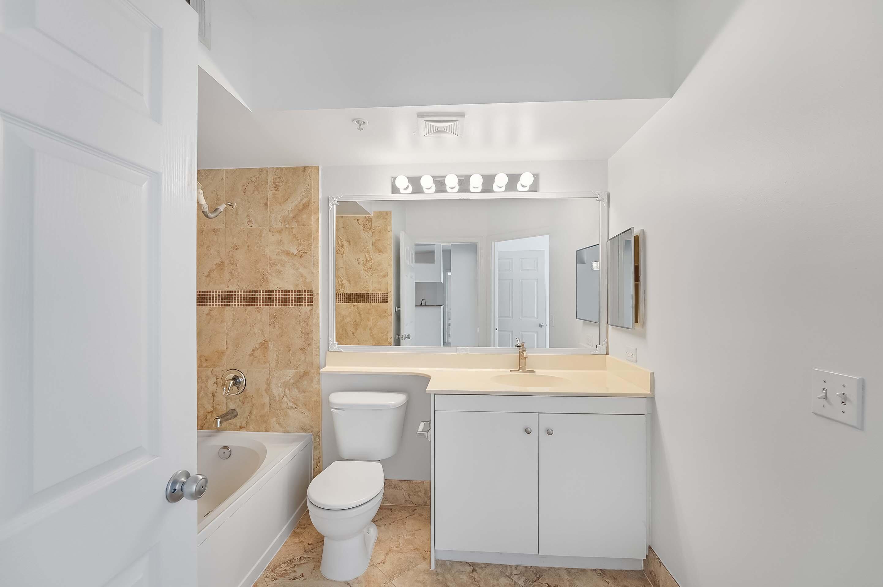 3115 Tuscany Way Boynton Beach, FL 33435 - Photo 24 of 49 a view of bathroom with a sink toilet mirror and tub