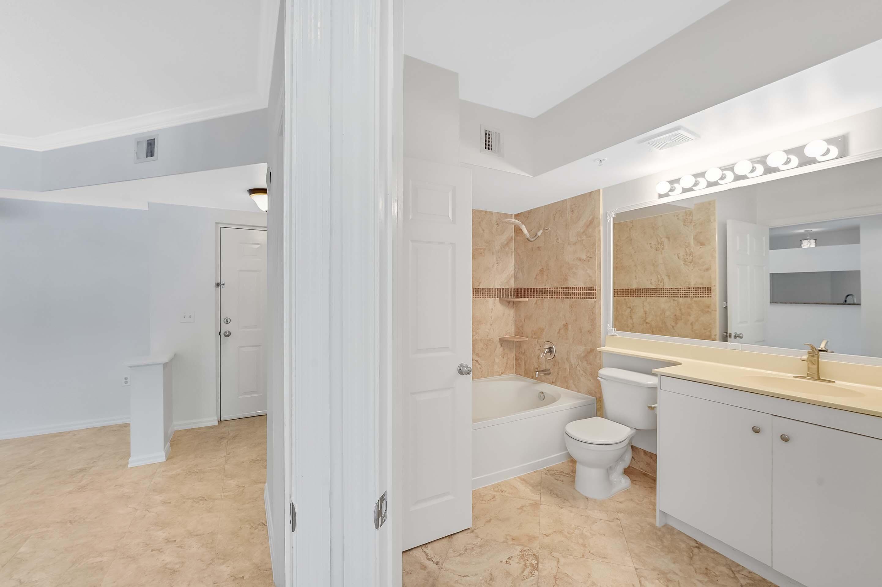 3115 Tuscany Way Boynton Beach, FL 33435 - Photo 25 of 49 a bathroom with a toilet sink shower and bathtub