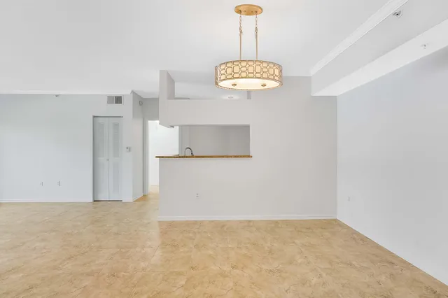 a kitchen with white cabinets and appliances
