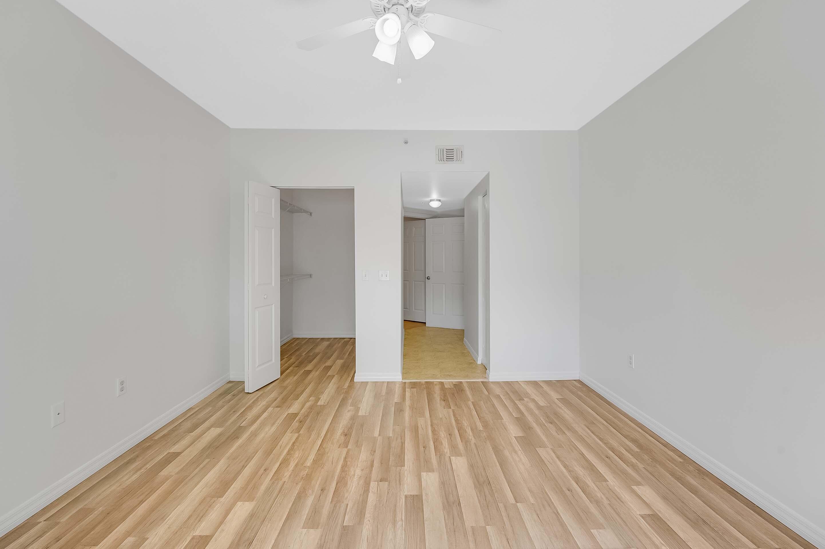 3115 Tuscany Way Boynton Beach, FL 33435 - Photo 36 of 49 a view of a room with wooden floor and a ceiling fan