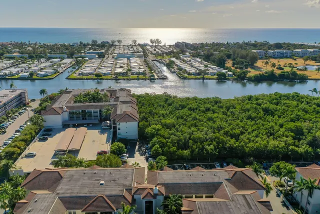 an aerial view of a city with lots of residential buildings lake and ocean view