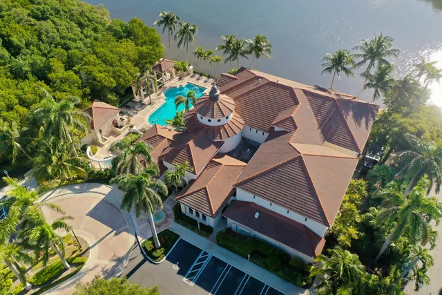 an aerial view of a house with a yard and potted plants