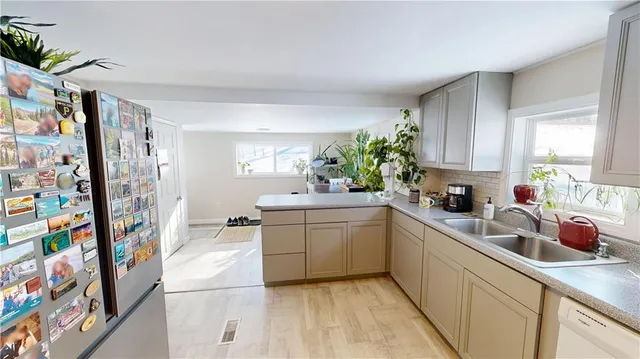 a kitchen with stainless steel appliances a sink and a refrigerator