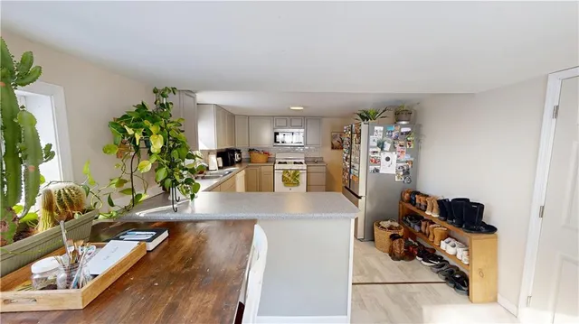 a view of a kitchen with workspace and a window