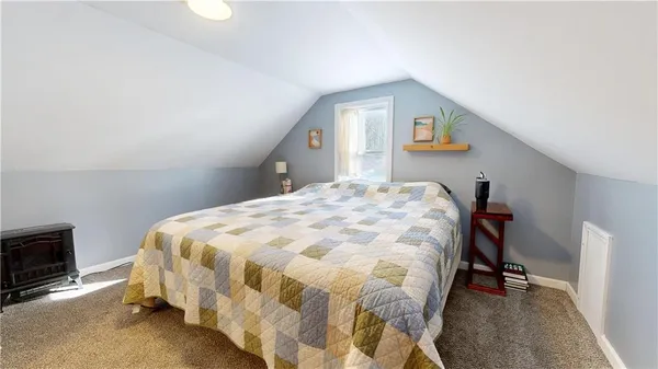 a bedroom with a bed and a tv
