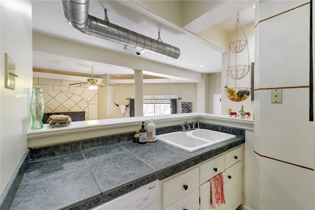 a kitchen with a sink and a refrigerator