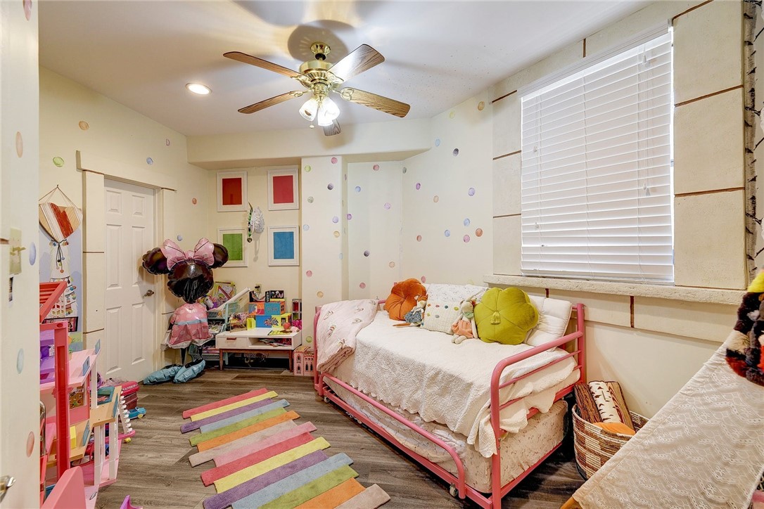 1712 Lakeshore Drive, Unit A Austin, TX 78746 - Photo 12 of 15 a bedroom with a bed and a chandelier