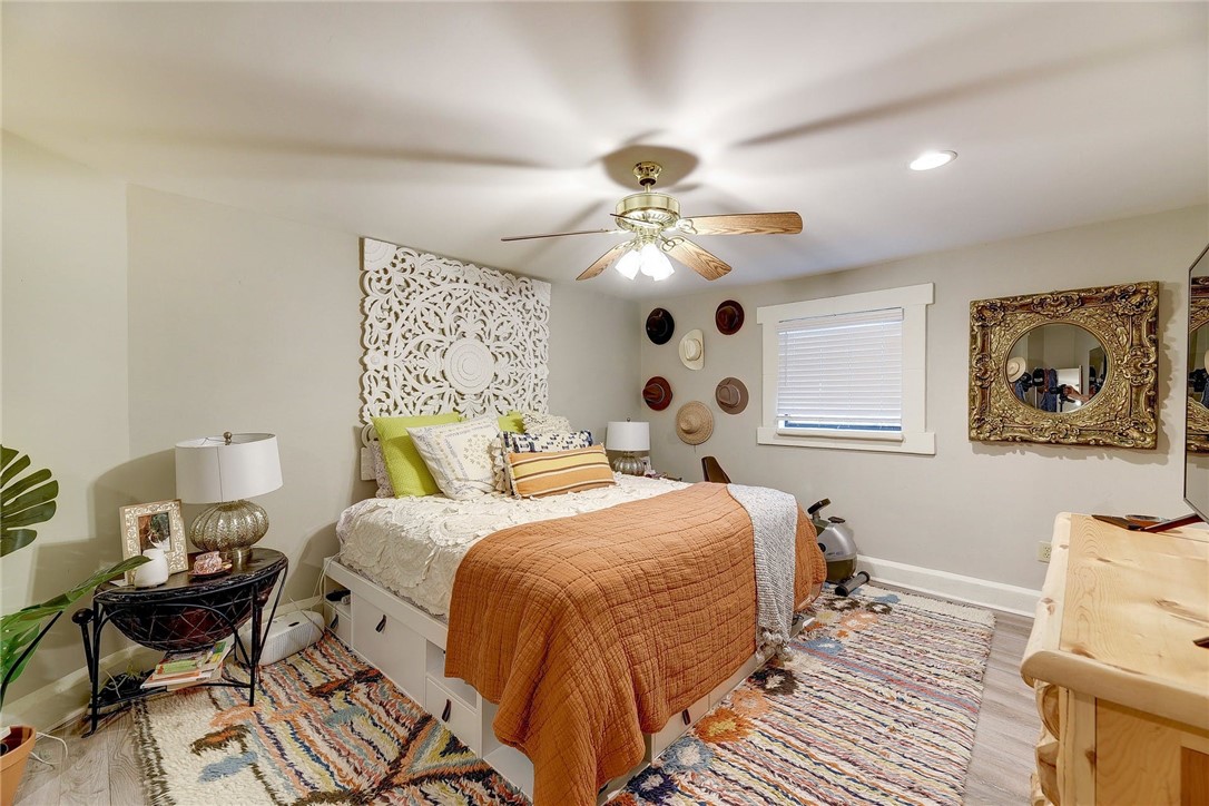 1712 Lakeshore Drive, Unit A Austin, TX 78746 - Photo 5 of 15 a bedroom with a bed and a chandelier