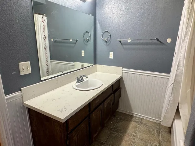 a bathroom with a sink a vanity and a mirror
