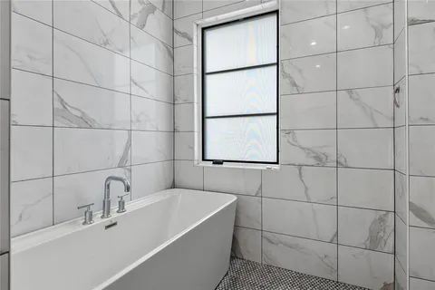 a bedroom with a bed and glass window