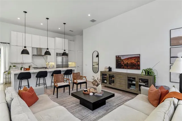 a living room with furniture kitchen view and a fireplace