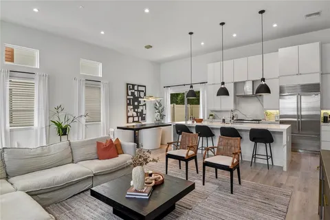 a living room with furniture kitchen and a table