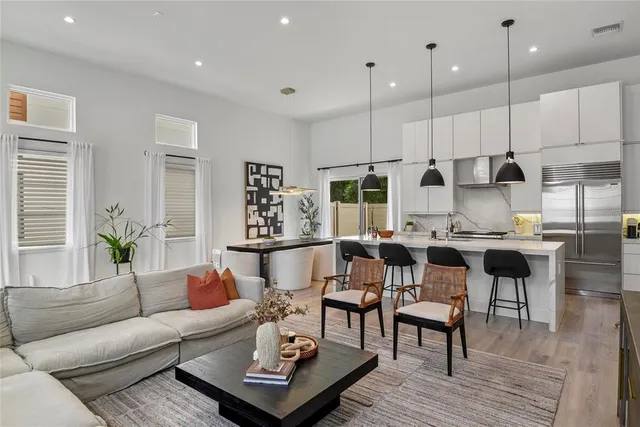a living room with furniture kitchen and a table
